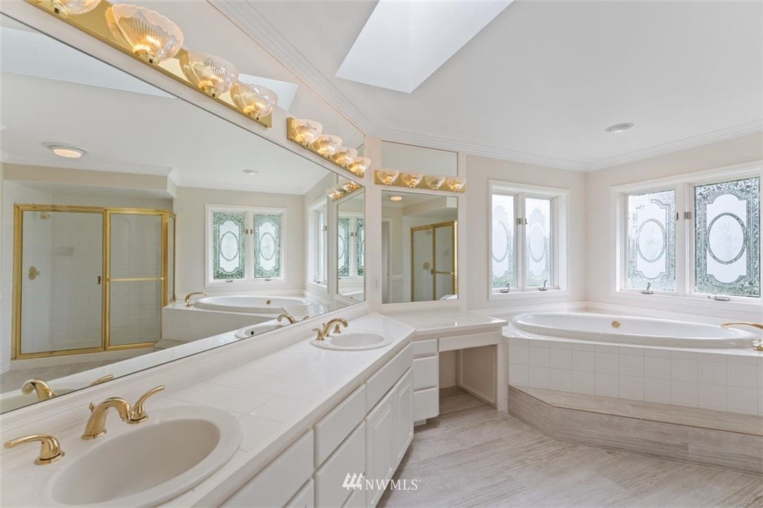 4801 166th Place Southeast Bothell, WA 98012 - Photo 24 of 40 a spacious bathroom with a double vanity sink mirror double and bathtub