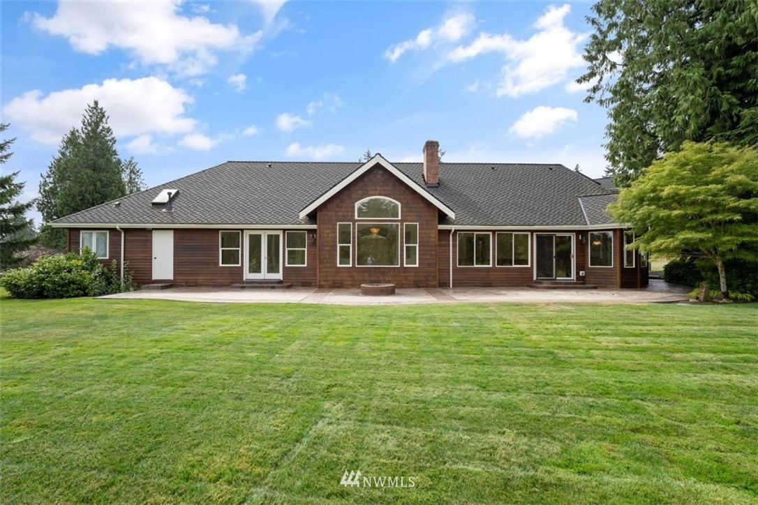 4801 166th Place Southeast Bothell, WA 98012 - Photo 34 of 40 a front view of a house with a garden
