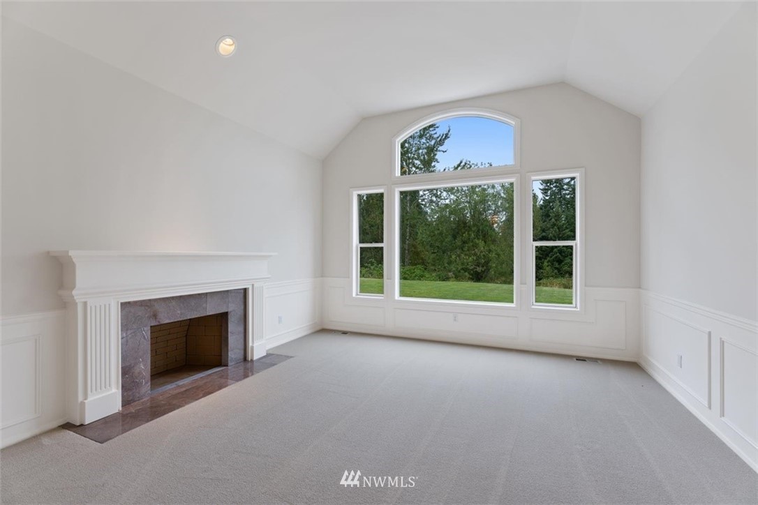 4801 166th Place Southeast Bothell, WA 98012 - Photo 6 of 40 a view of an empty room with a fireplace and a window