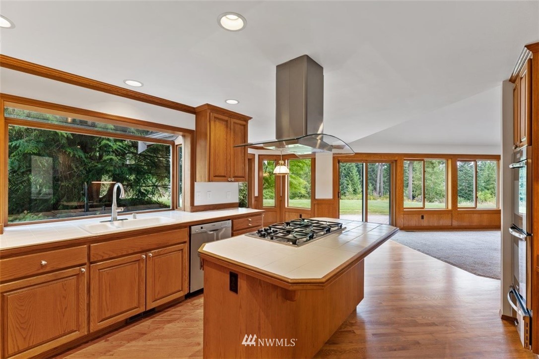 4801 166th Place Southeast Bothell, WA 98012 - Photo 9 of 40 a kitchen with a sink and wooden cabinets