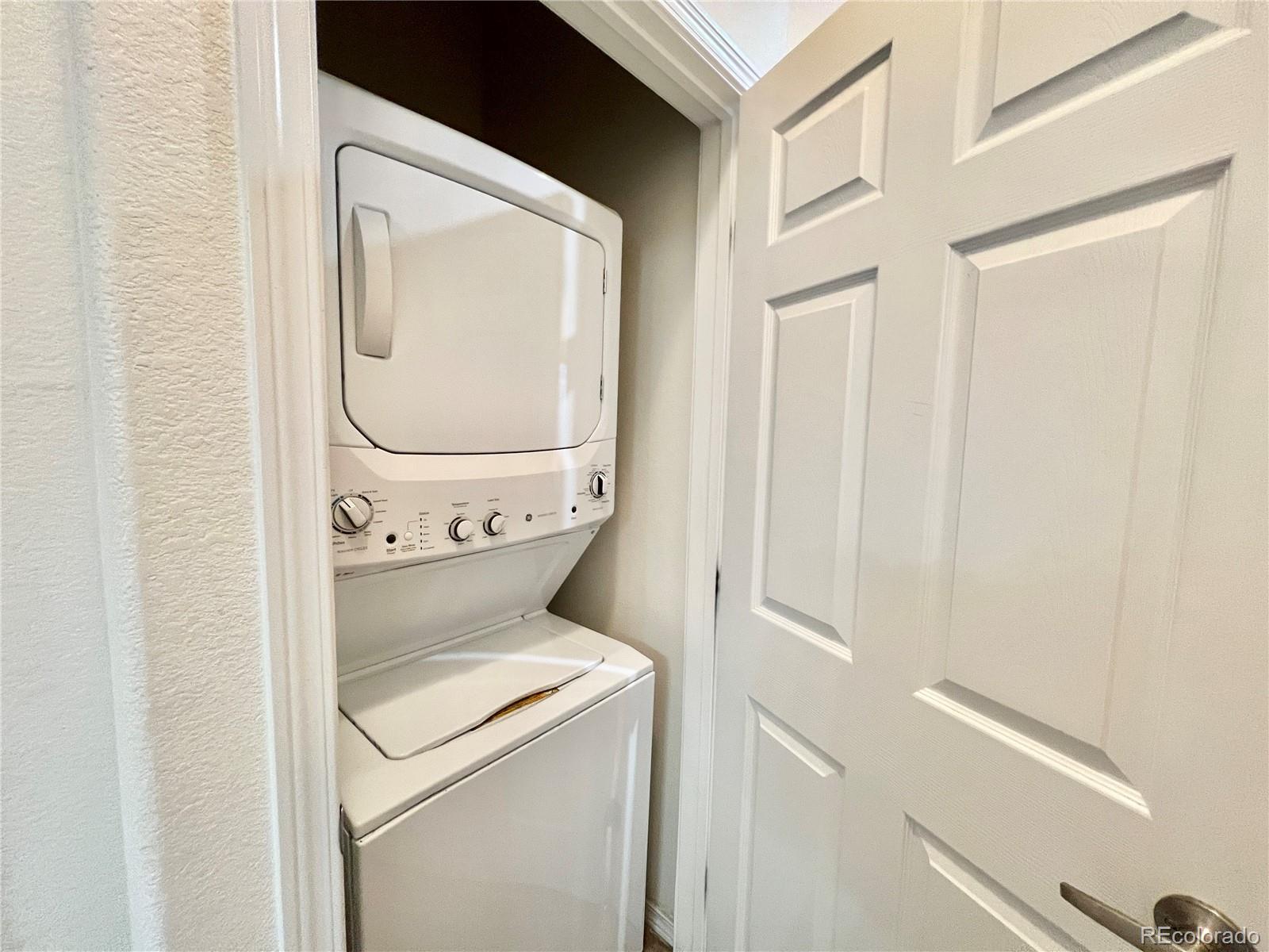 8467 Canyon Rim Circle, Unit 303 Parker, CO 80134 - Photo 16 of 17 a utility room with dryer and washer