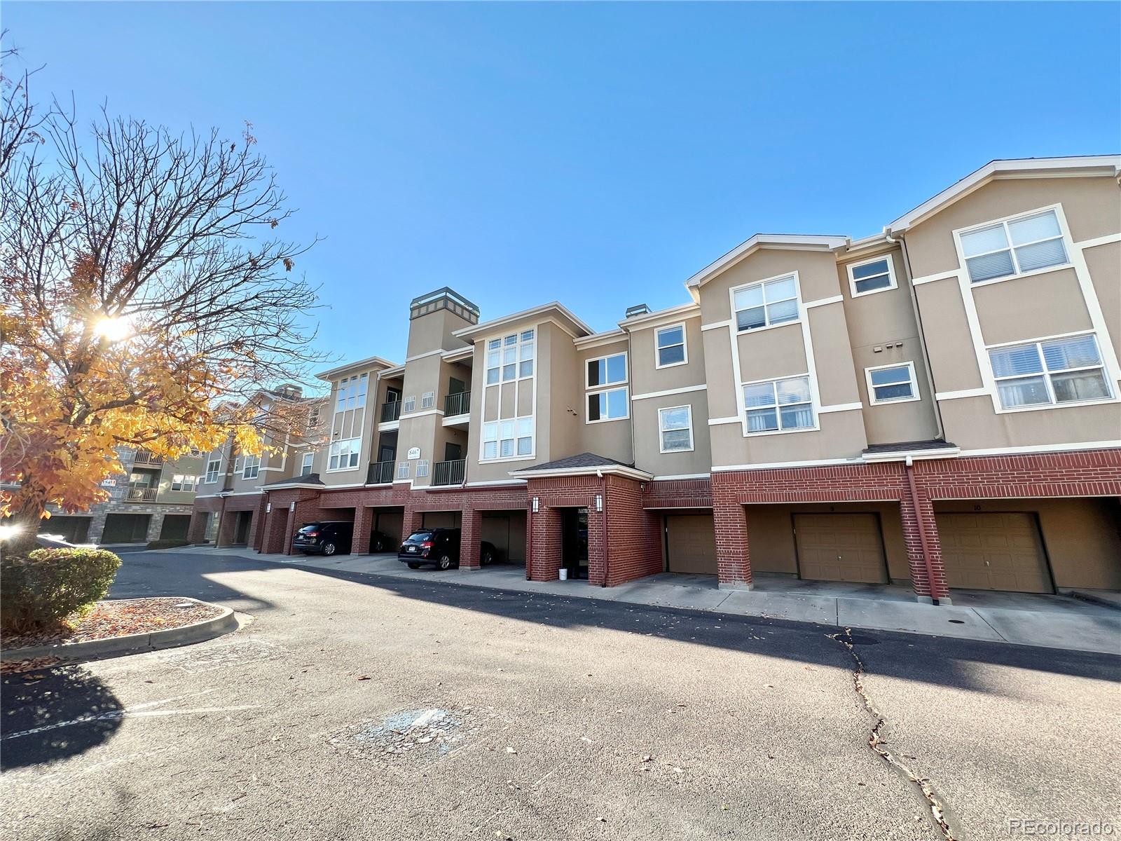 8467 Canyon Rim Circle, Unit 303 Parker, CO 80134 - Photo 2 of 17 a front view of a building with glass windows