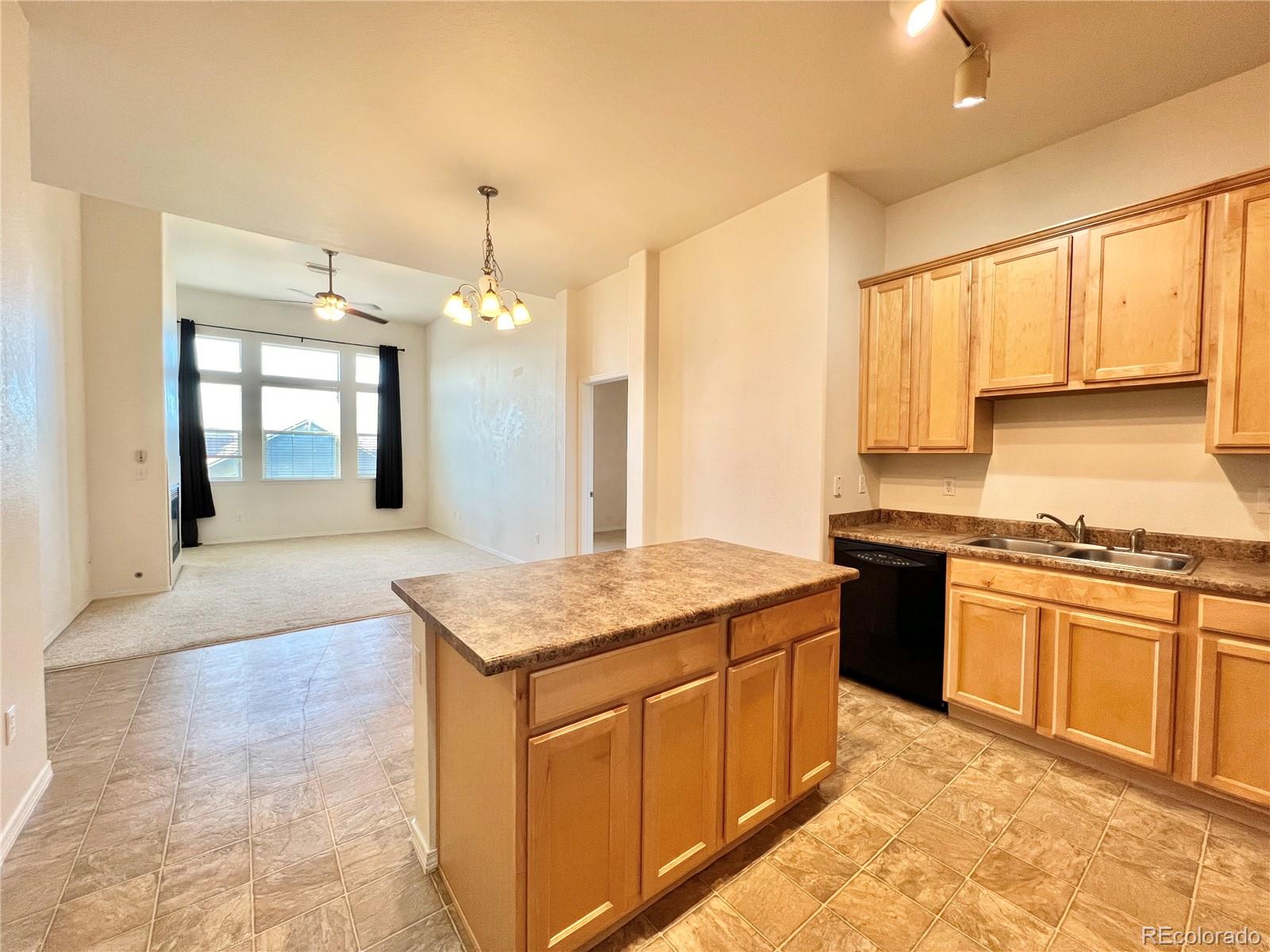 8467 Canyon Rim Circle, Unit 303 Parker, CO 80134 - Photo 5 of 17 a kitchen with stainless steel appliances granite countertop a sink stove and cabinets