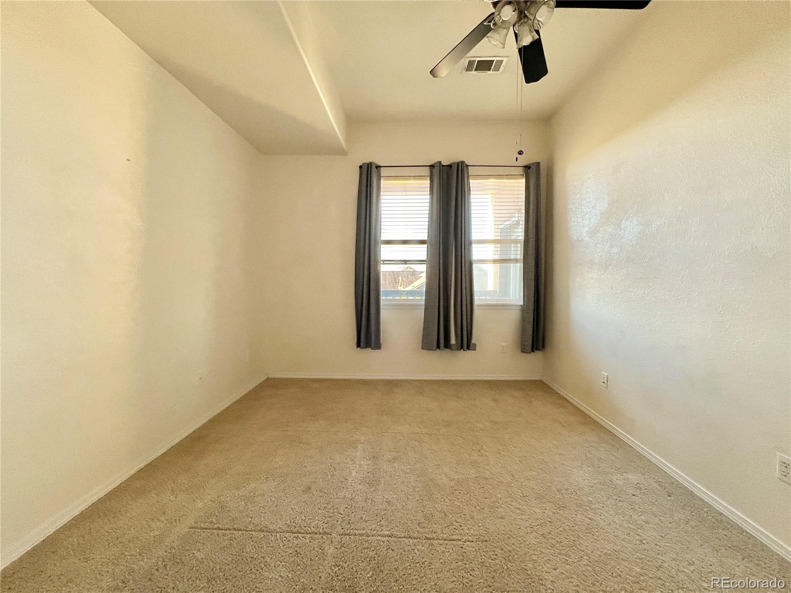 8467 Canyon Rim Circle, Unit 303 Parker, CO 80134 - Photo 8 of 17 a view of an empty room with a window