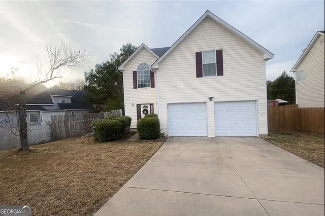 a view of a house with a yard and garage