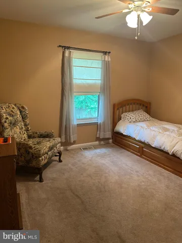 a bed sitting in a room next to a window