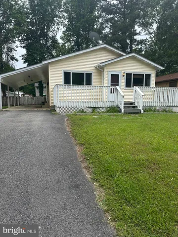 a front view of a house with a garden and porch