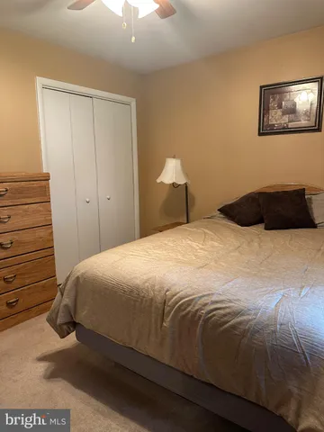 a bedroom with a bed and a night stand