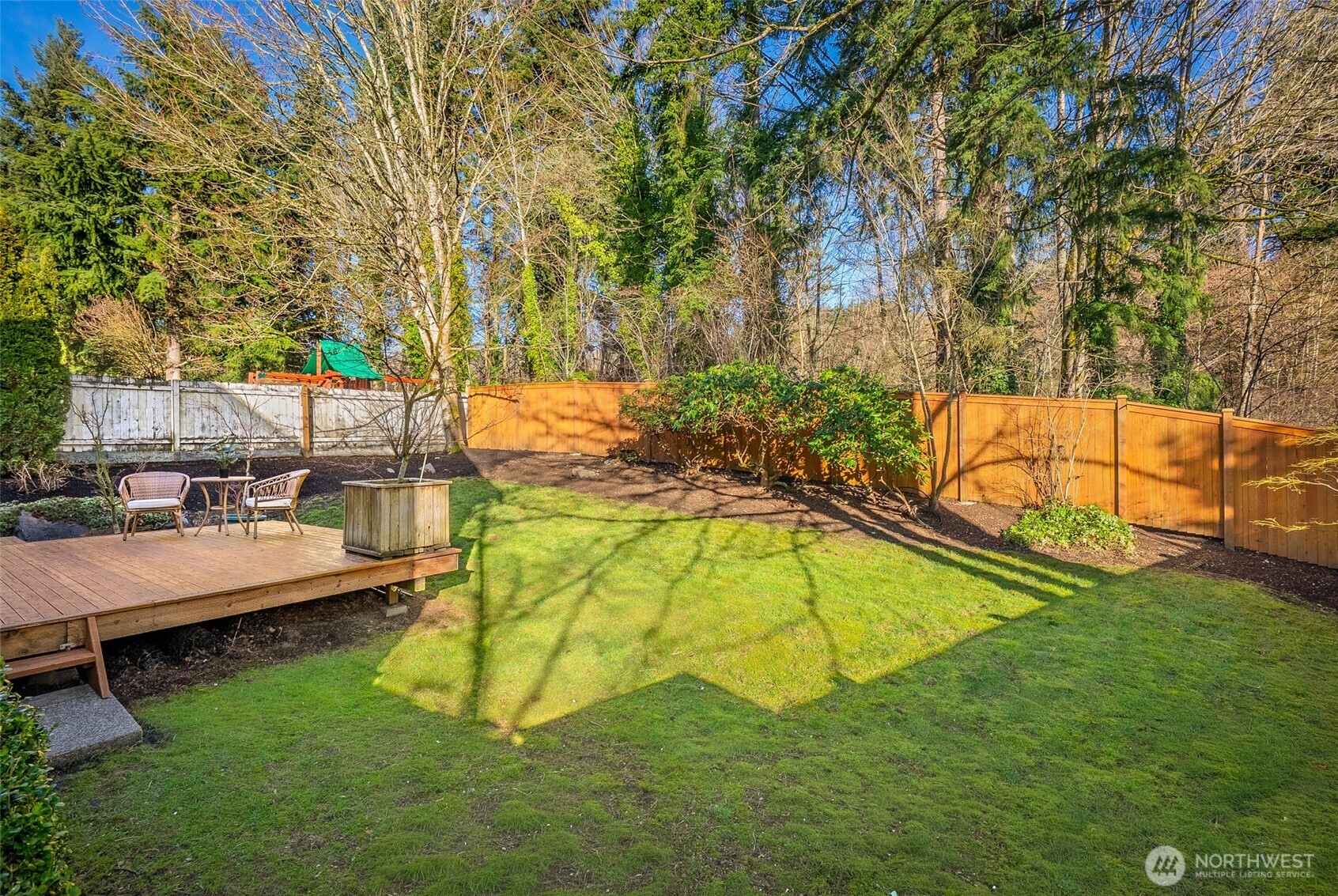 22709 12th Place West Bothell, WA 98021 - Photo 15 of 27 a view of swimming pool with a bench and trees in the background