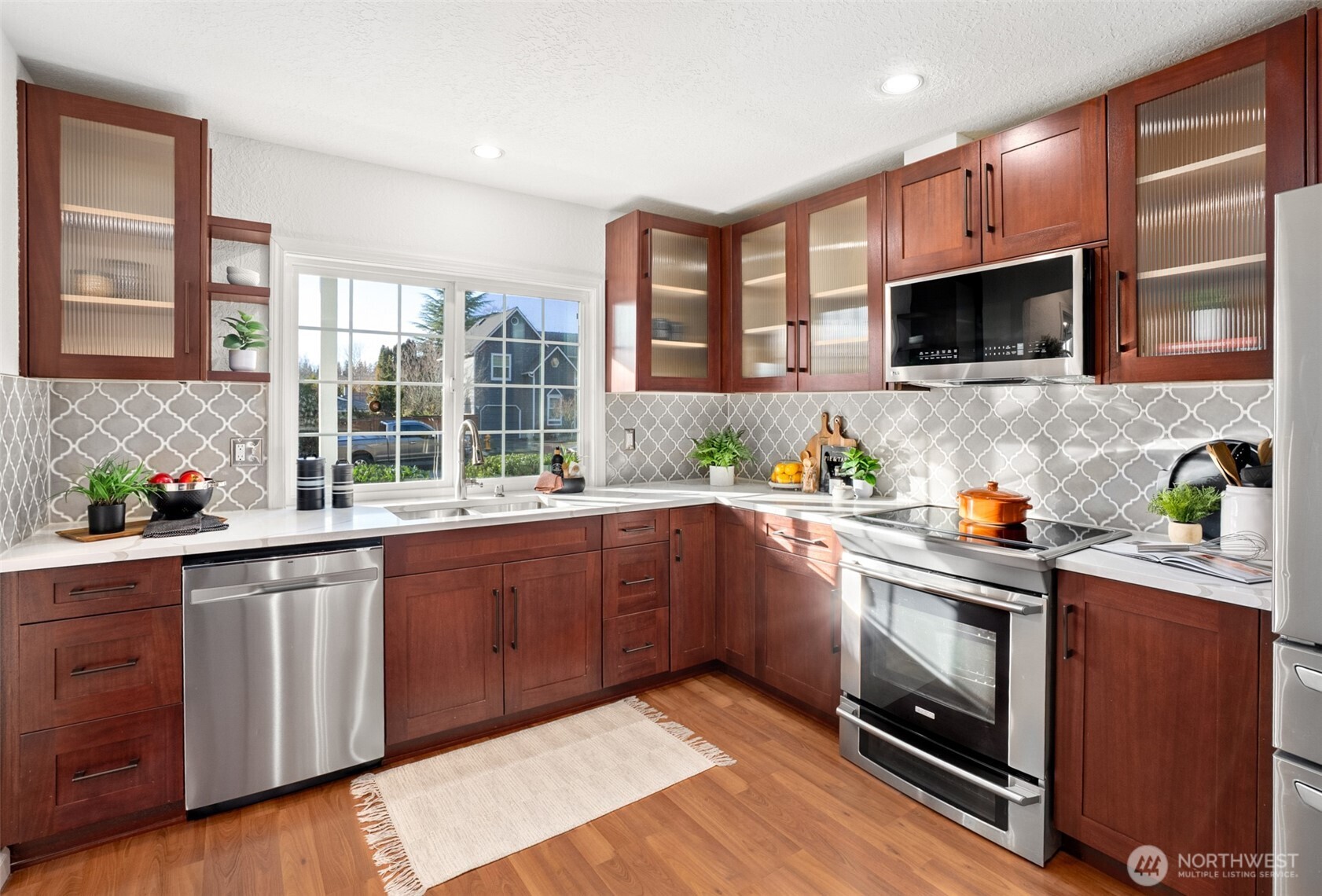 22709 12th Place West Bothell, WA 98021 - Photo 3 of 27 a kitchen with stainless steel appliances wooden cabinets and a stove top oven
