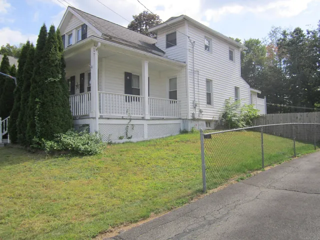 a view of a house with backyard and trees