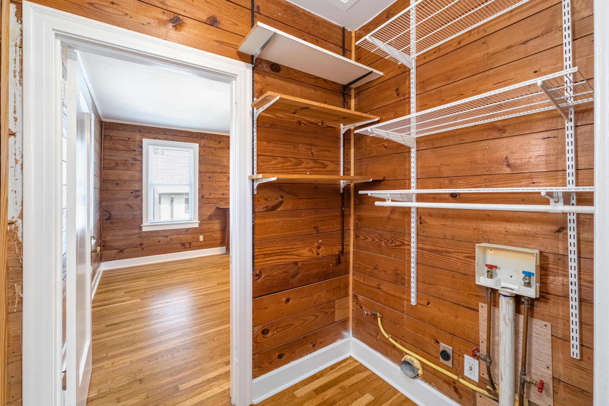 2012 Enfield Road, Unit B Austin, TX 78703 - Photo 20 of 20 Functional utility space with durable wood paneling and practical shelving.