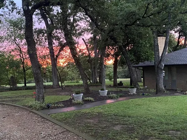 a backyard of a house with table and chairs