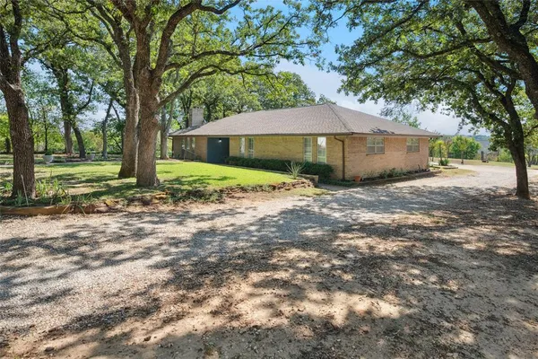 a house that has a tree in front of it