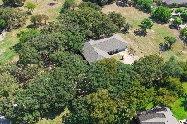 a view of open field with trees in the background