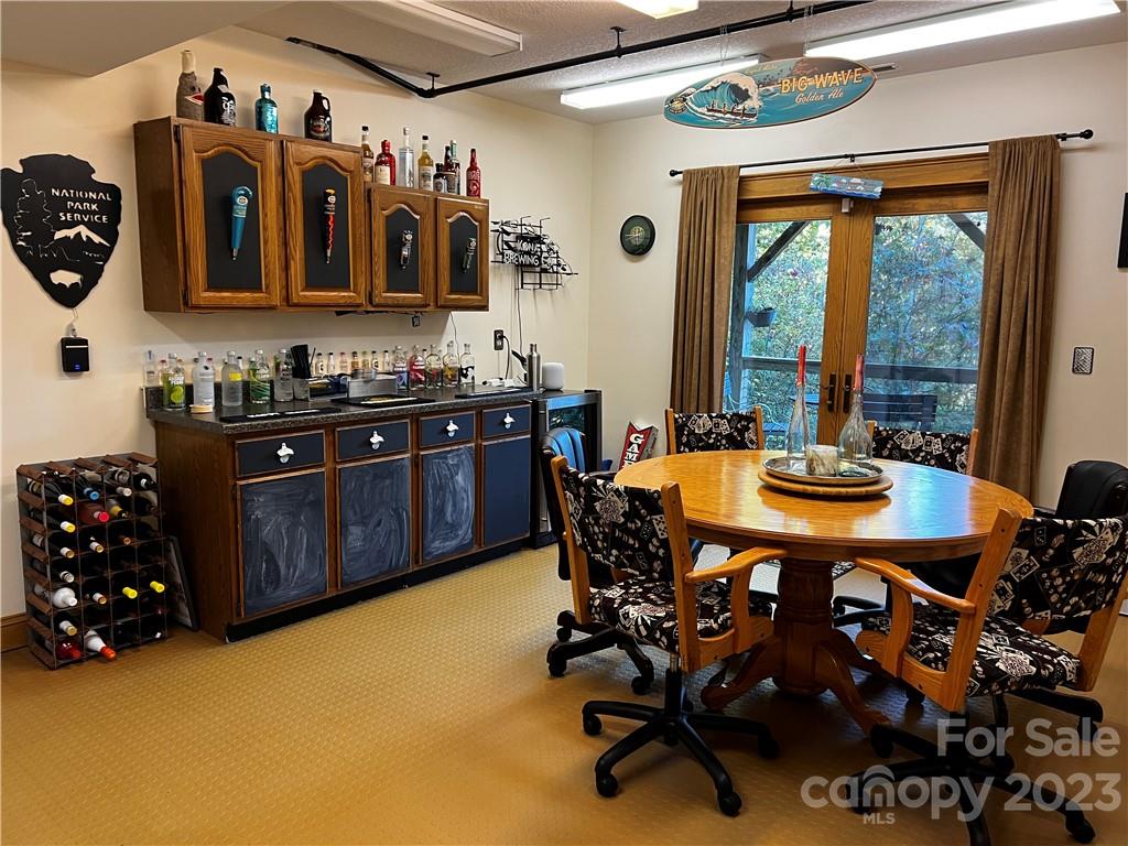 159 Deer Leap Marshall, NC 28753 - Photo 22 of 22 a kitchen with stainless steel appliances granite countertop a stove a sink and a dining table with garden view