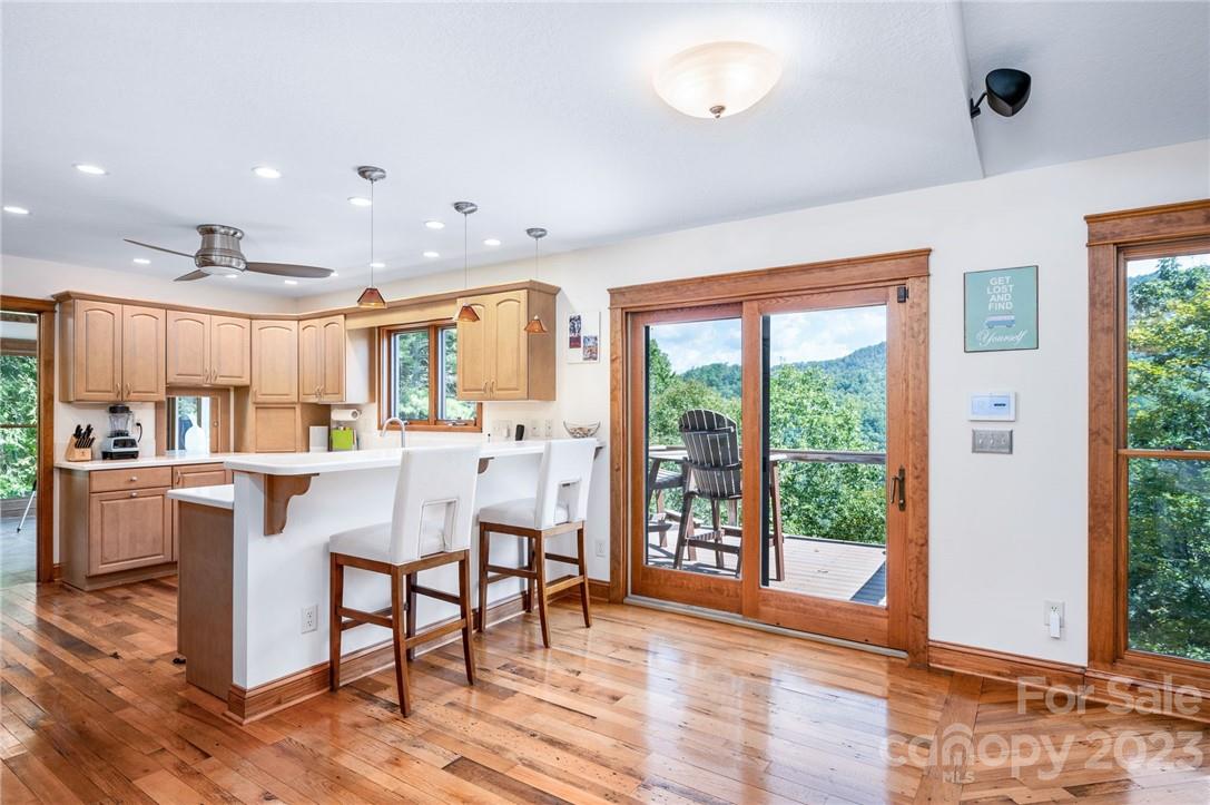 159 Deer Leap Marshall, NC 28753 - Photo 7 of 22 a dining hall with stainless steel appliances a dining table wooden floor and a large window