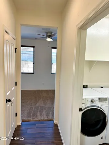 a view of a hallway with washer and dryer