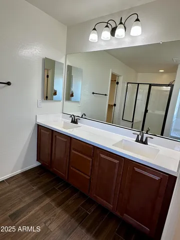 a bathroom with a double vanity sink and a mirror