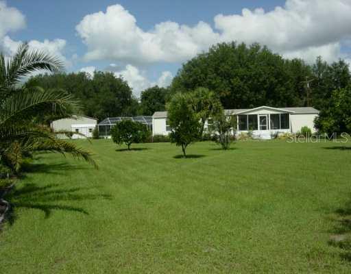 3937 Allen Road Zephyrhills, FL 33541 - Photo 1 of 1 a front view of a house with a garden