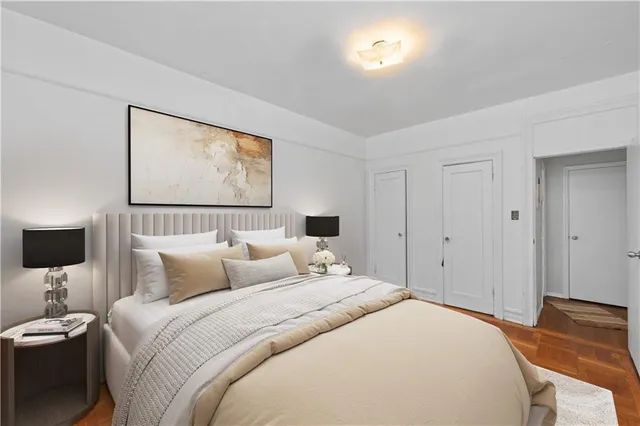 a bedroom with a bed and a night stand