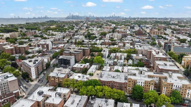 an aerial view of residential houses with city view