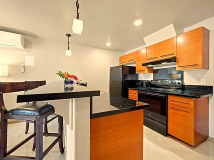 a kitchen with stainless steel appliances granite countertop a stove a refrigerator and a sink