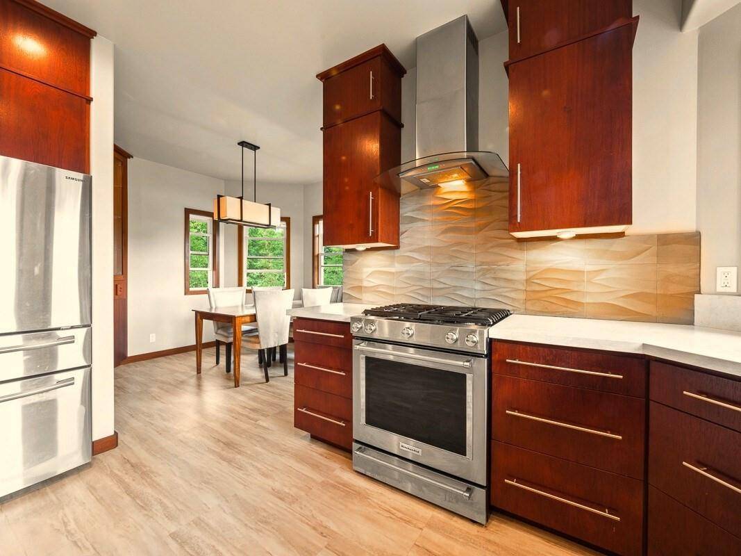 23 Machida Lane Hilo, HI 96720 - Photo 6 of 30 a kitchen with stainless steel appliances granite countertop a stove a sink and a refrigerator