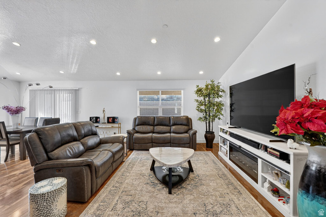 141 Wolverine Creek Elk Ridge, UT 84651 - Photo 5 of 47 Living area with wood finished floors, a textured ceiling, and recessed lighting