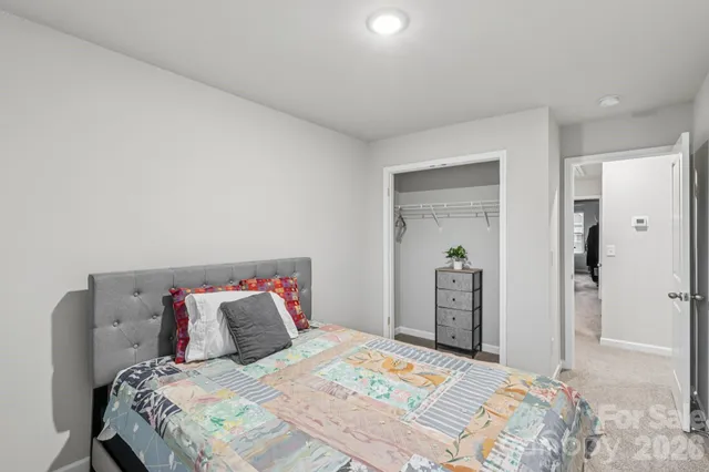 a bedroom with a bed and a closet