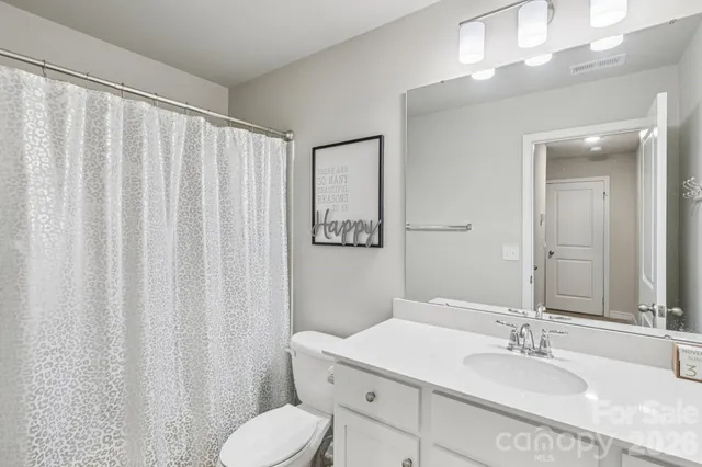 a bedroom with a large bed and a ceiling fan