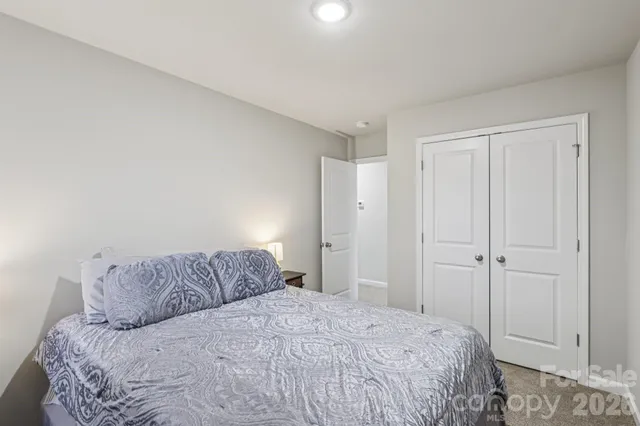a bathroom with a double vanity sink a mirror and a shower