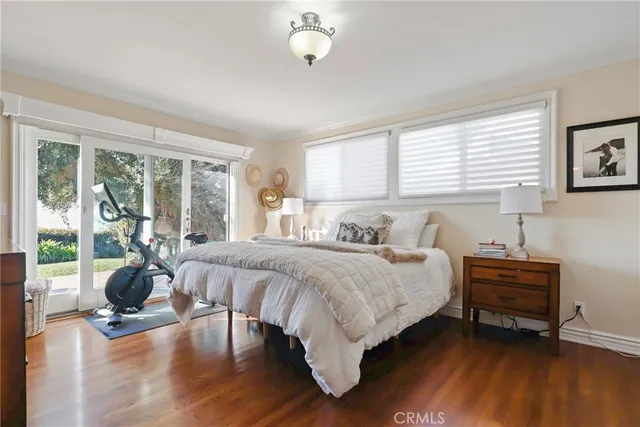 a bedroom with bed and a large window