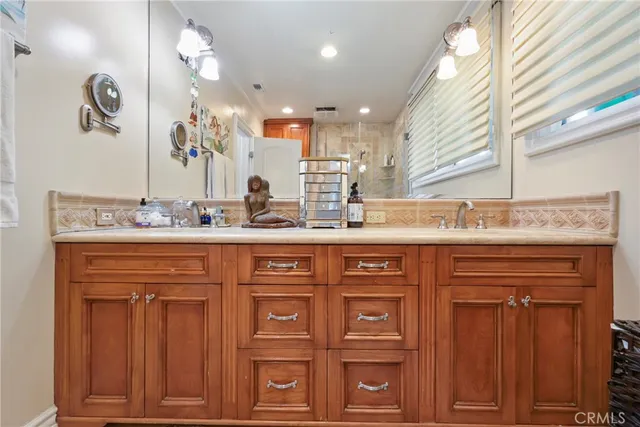 a bathroom with a sink double vanity and a mirror