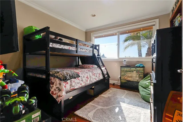 a bedroom with a bed table and a window