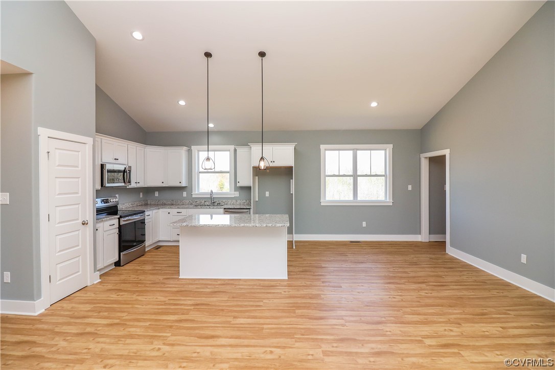 288 Moore Road Pamplin, VA 23958 - Photo 11 of 29 a kitchen with stainless steel appliances granite countertop a refrigerator a sink dishwasher a stove and white countertops with wooden floor