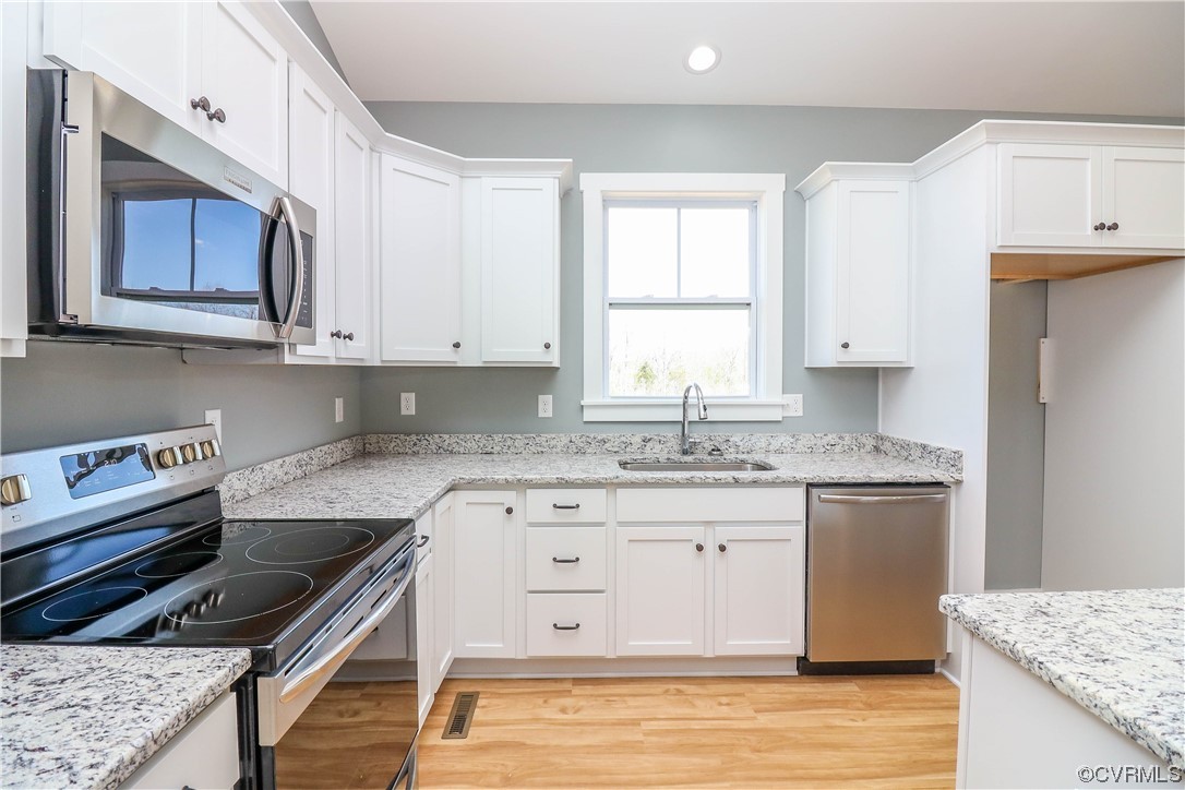 288 Moore Road Pamplin, VA 23958 - Photo 13 of 29 a kitchen with granite countertop a stove sink and cabinets