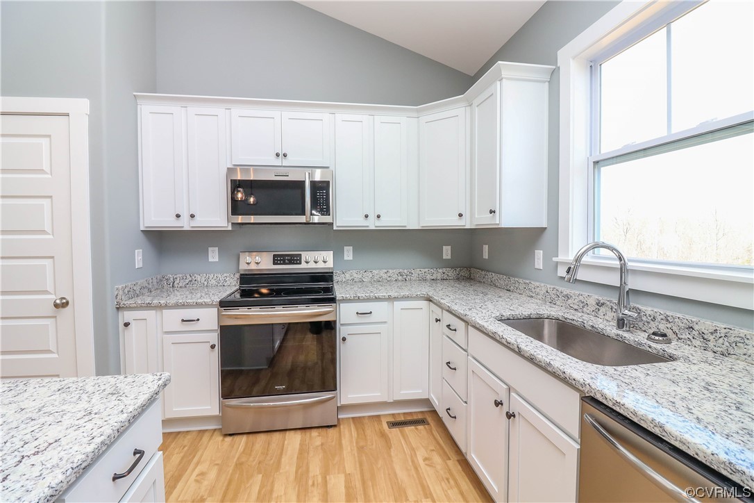288 Moore Road Pamplin, VA 23958 - Photo 15 of 29 a kitchen with granite countertop a stove sink and microwave
