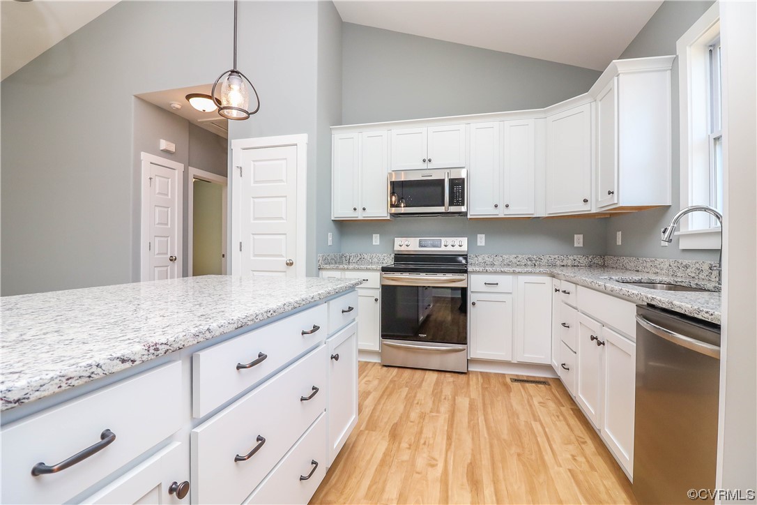 288 Moore Road Pamplin, VA 23958 - Photo 16 of 29 a kitchen with granite countertop white cabinets and stainless steel appliances