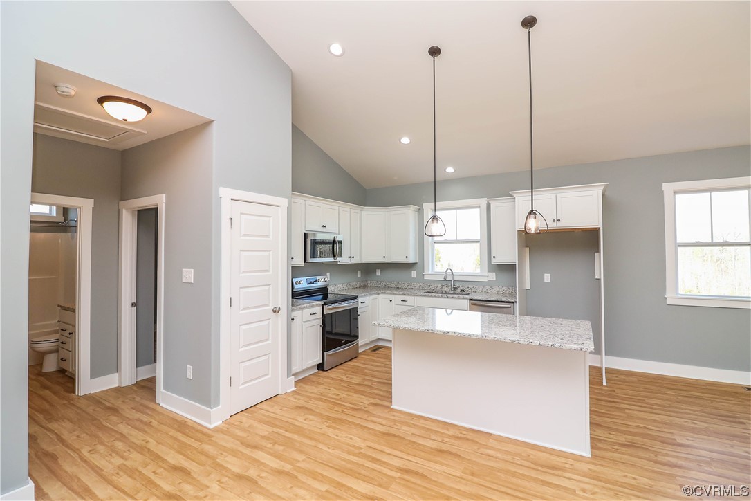 288 Moore Road Pamplin, VA 23958 - Photo 18 of 29 a large kitchen with cabinets wooden floor and a window