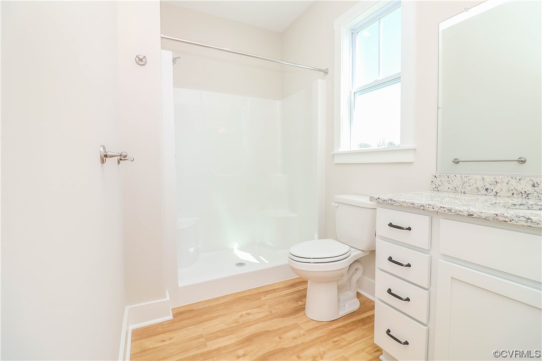 288 Moore Road Pamplin, VA 23958 - Photo 23 of 29 a bathroom with a granite countertop toilet a sink and a window