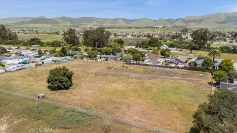 an aerial view of residential houses with city view