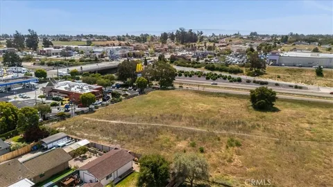an aerial view of a house with a yard and lake view