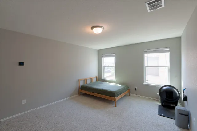 a bed room with a bed and a window