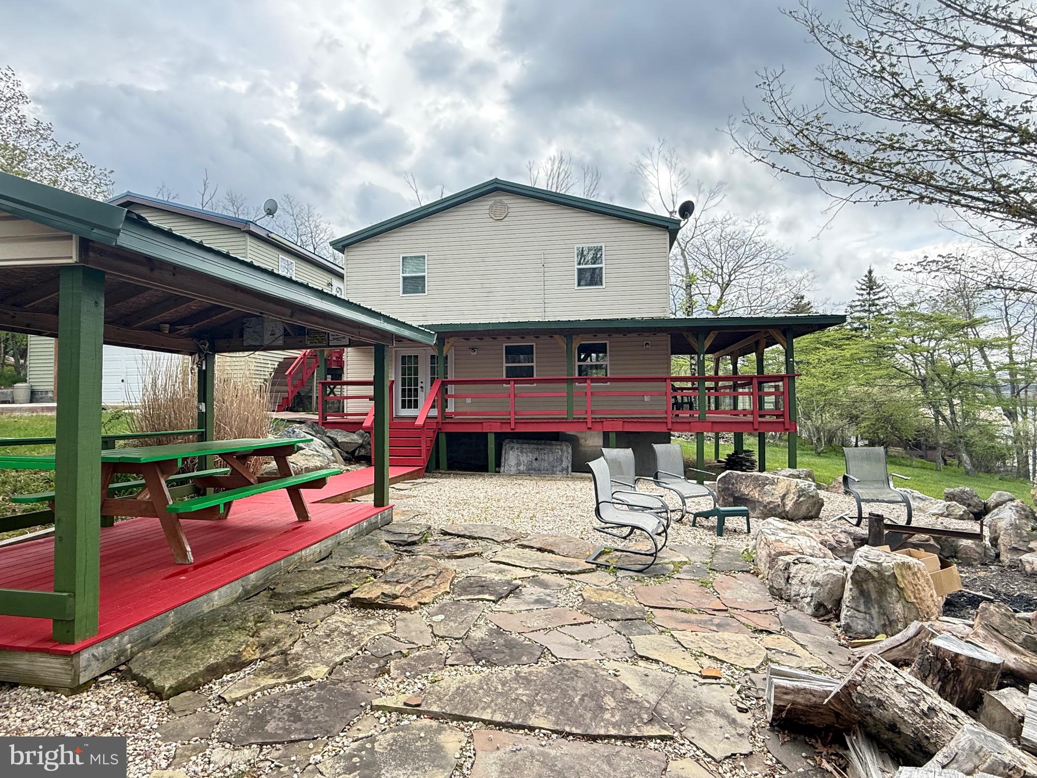 106 North Rock Ridge Lane Mount Storm, WV 26739 - Photo 32 of 78 a view of the patio with dining table and chairs under an umbrella