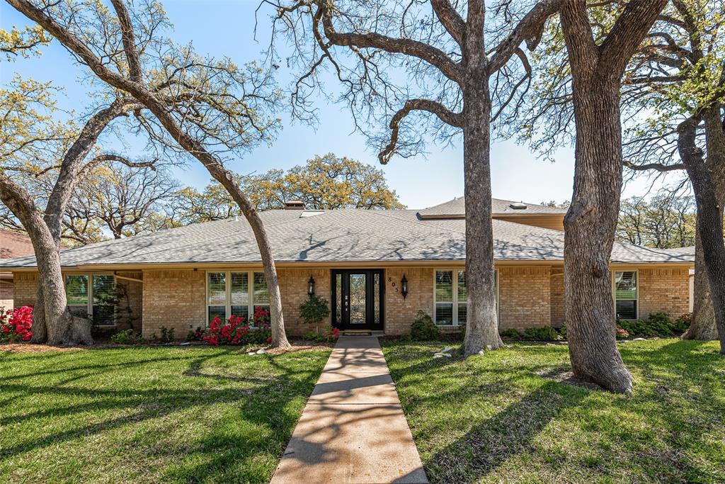 805 Crowley Road Arlington, TX 76012 - Photo 1 of 26 a front view of a house with a garden and trees