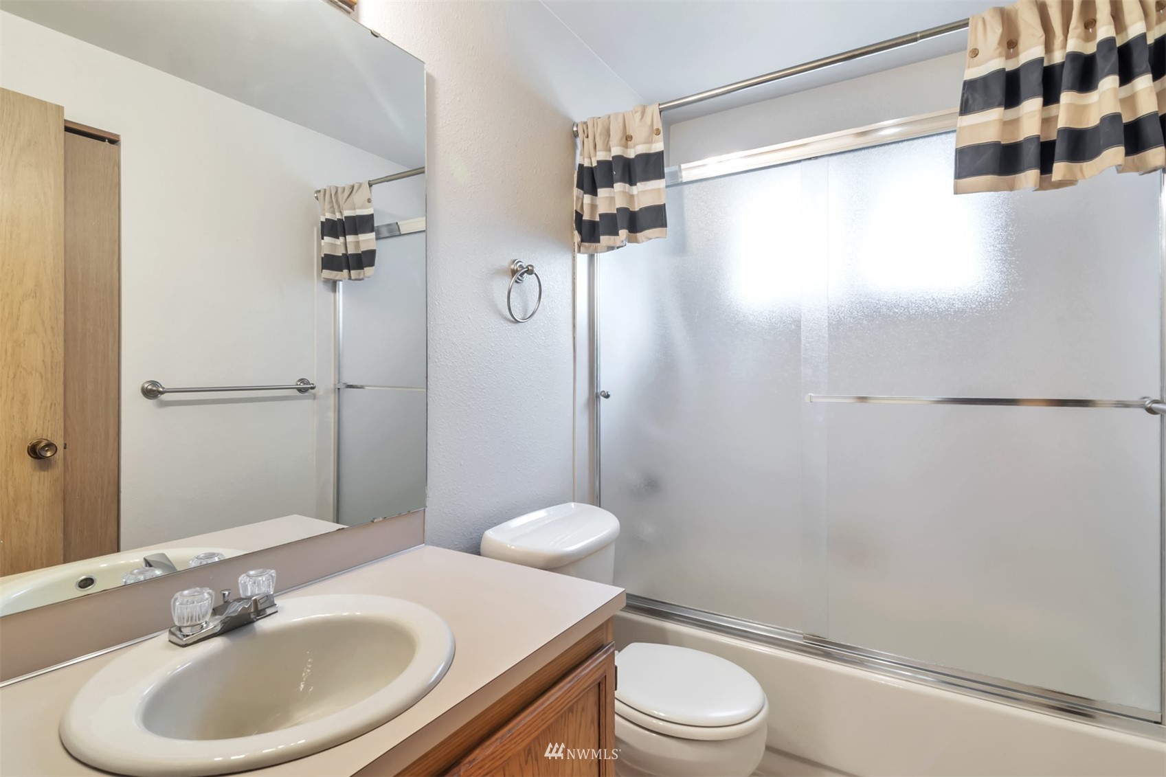 18221 26th Drive Southeast Bothell, WA 98012 - Photo 15 of 25 a bathroom with a sink toilet and shower