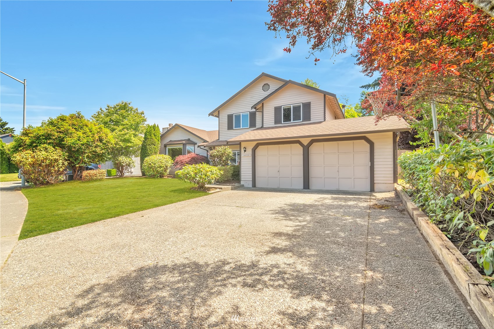 18221 26th Drive Southeast Bothell, WA 98012 - Photo 2 of 25 a front view of a house with a yard and garage