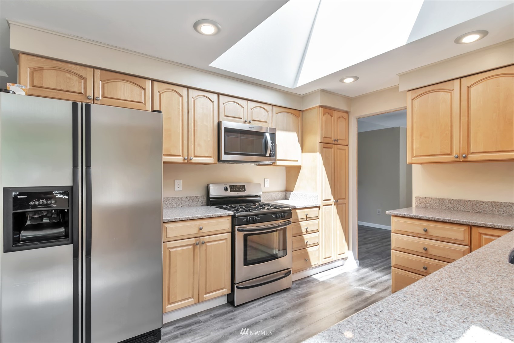 18221 26th Drive Southeast Bothell, WA 98012 - Photo 7 of 25 a kitchen with stainless steel appliances granite countertop a refrigerator stove and sink