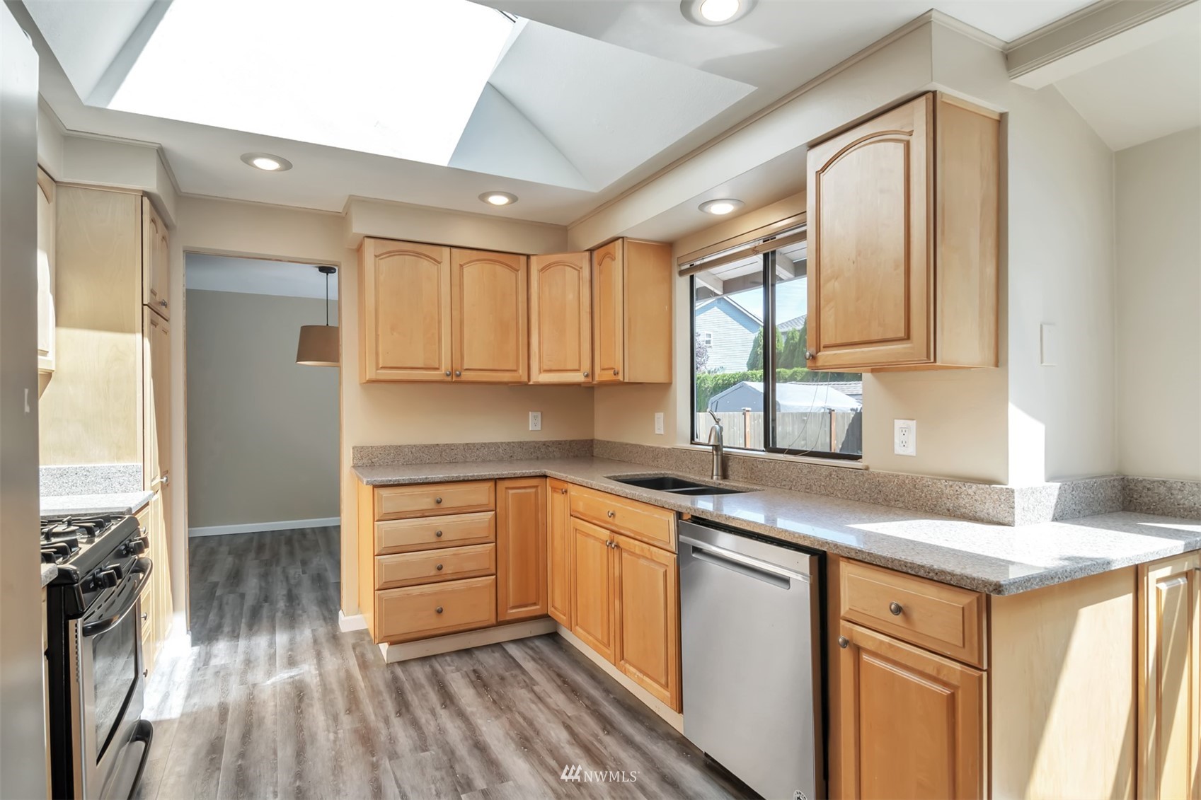 18221 26th Drive Southeast Bothell, WA 98012 - Photo 8 of 25 a kitchen with granite countertop a sink stainless steel appliances and cabinets